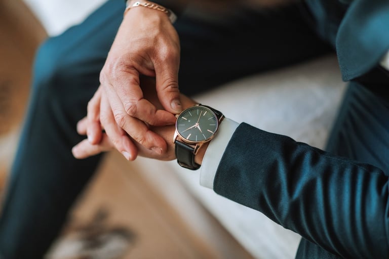 A man wearing a watch and looking at it