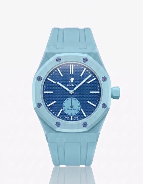 Light blue Swatch watch with dark blue dial, white hour markers, and rubber strap on white background